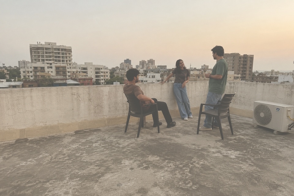 Three friends talking on a residential rooftop terrace.